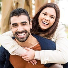 Man and woman smiling outdoors