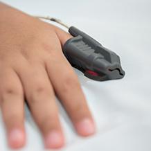 Closeup of finger with oxygen saturation monitor