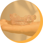 Hand holding sleep apnea appliance highlighted