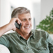 Smiling man talking on cellphone