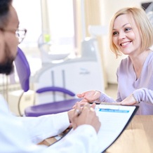 Woman talking to dentist about oral appliance therapy