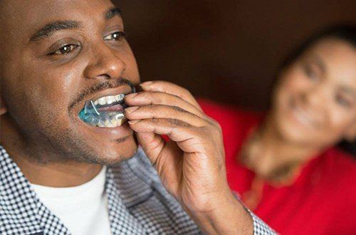 Man placing sleep apnea appliance