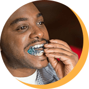 Man placing oral appliance