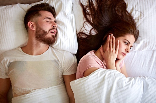 woman annoyed by partner’s snoring