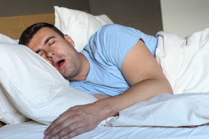 Man with sleep apnea drooling in bed