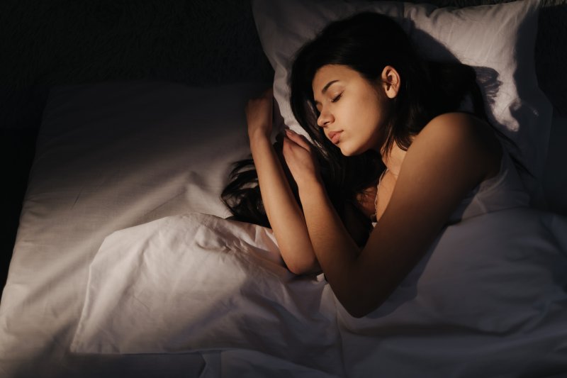 Woman sleeping after using CBD for her sleep apnea